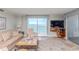 Inviting living room with comfortable furnishings, scenic ocean views, and access to the balcony at 9820 Queensway Blvd. # 1210, Myrtle Beach, SC 29572