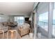 Cozy living room showcasing breathtaking ocean views, neutral decor, and access to a private balcony at 9820 Queensway Blvd. # 1210, Myrtle Beach, SC 29572