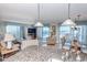 Bright living room with stunning ocean views, tile floors, comfortable seating, and access to a balcony at 9820 Queensway Blvd. # 1210, Myrtle Beach, SC 29572