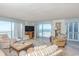 Bright living room with balcony access, a comfortable seating arrangement, and ocean views at 9820 Queensway Blvd. # 1210, Myrtle Beach, SC 29572