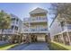 Charming three-story beach house with multiple balconies and street view at 113B 15Th Ave. S, Surfside Beach, SC 29575