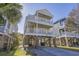 Stunning raised beach house with multiple balconies, offering breathtaking views and outdoor living space at 113B 15Th Ave. S, Surfside Beach, SC 29575