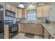 Functional kitchen with natural wood cabinets and modern appliances, designed for convenience and style at 113B 15Th Ave. S, Surfside Beach, SC 29575