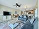 Cozy living room with tile floors, ceiling fan, and comfortable seating, flowing into an open-concept kitchen and dining area at 113B 15Th Ave. S, Surfside Beach, SC 29575