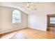 Bright, spacious bedroom features wood-look flooring, neutral paint, and an arched window at 1161 Ganton Way, Myrtle Beach, SC 29588