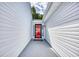 Covered entryway leading to a vibrant red front door, offering curb appeal and protection from the elements at 1161 Ganton Way, Myrtle Beach, SC 29588