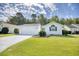 Charming single-story home featuring a manicured lawn, attached garage, and a vibrant red front door at 1161 Ganton Way, Myrtle Beach, SC 29588