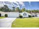 Charming single-story home featuring a manicured lawn, attached garage, and a vibrant red front door at 1161 Ganton Way, Myrtle Beach, SC 29588