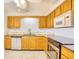Functional kitchen with wood cabinetry, stainless steel appliances, and tile countertops at 1161 Ganton Way, Myrtle Beach, SC 29588