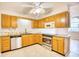 Traditional kitchen with oak cabinets, tile flooring, stainless steel appliances, and a granite countertop at 1161 Ganton Way, Myrtle Beach, SC 29588