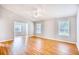 Spacious living room features wood-look flooring, light grey walls, and two windows for lots of natural light at 1161 Ganton Way, Myrtle Beach, SC 29588