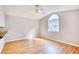 Bright living room featuring light hardwood floors, a ceiling fan, and a large arched window at 1161 Ganton Way, Myrtle Beach, SC 29588