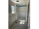 Bathroom featuring a shower enclosure and a window, providing ventilation and natural light in this home under construction at 1280 Highway 45, Loris, SC 29569