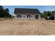 View of the back exterior featuring white sheathing and sliding glass doors at 1280 Highway 45, Loris, SC 29569