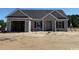 Charming single-story home featuring a garage, neutral siding, and classic black shutters at 1280 Highway 45, Loris, SC 29569