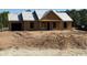 Under construction home with attached garage on a partially cleared lot in a neighborhood setting at 1284 Highway 45, Loris, SC 29569
