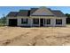 New construction home features a charming white exterior, black shutters, and an attached two-car garage at 1284 Highway 45, Loris, SC 29569