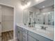 Bright bathroom featuring double sinks, gray cabinets, and a glass shower door at 191 Glengrove Lane, Murrells Inlet, SC 29576