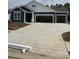 Charming exterior view of a modern home with a spacious three-car garage and concrete driveway at 191 Glengrove Lane, Murrells Inlet, SC 29576