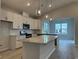 New kitchen with island, granite countertops, stainless appliances, and modern pendant lighting at 191 Glengrove Lane, Murrells Inlet, SC 29576
