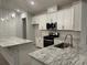 Modern kitchen with stainless steel appliances, granite countertops, and white cabinets at 191 Glengrove Lane, Murrells Inlet, SC 29576