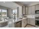 Gourmet kitchen featuring stainless appliances, a kitchen island with a quartz countertop, and backyard views at 191 Glengrove Lane, Murrells Inlet, SC 29576