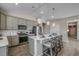Well-equipped kitchen with stainless steel appliances, gray cabinets, pendant lighting, and breakfast bar seating at 191 Glengrove Lane, Murrells Inlet, SC 29576