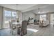 Bright, open-concept living and dining area with large windows, modern chandelier and luxury vinyl flooring at 191 Glengrove Lane, Murrells Inlet, SC 29576