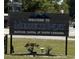 Sign welcomes visitors to Murrells Inlet, Seafood Capital of South Carolina, next to a grassy field at 191 Glengrove Lane, Murrells Inlet, SC 29576