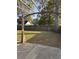 Spacious backyard with mature trees, a wooden fence, and a pergola-covered patio at 445 Saint Charles Circle, Myrtle Beach, SC 29588