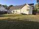 Manicured backyard showcasing a well maintained lawn and the home's rear facade at 445 Saint Charles Circle, Myrtle Beach, SC 29588