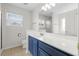 Bathroom featuring a large mirror, blue vanity, and a white toilet at 445 Saint Charles Circle, Myrtle Beach, SC 29588