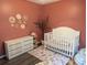 A cozy Bedroom with a white crib, dresser and natural decor at 445 Saint Charles Circle, Myrtle Beach, SC 29588