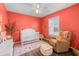 Cozy Bedroom with coral walls and a white crib at 445 Saint Charles Circle, Myrtle Beach, SC 29588