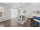 Open dining room with wood floors, a modern light fixture and a four person dining set at 445 Saint Charles Circle, Myrtle Beach, SC 29588