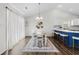 Bright dining area featuring modern chandelier and stylish blue accent rug at 445 Saint Charles Circle, Myrtle Beach, SC 29588