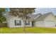 Inviting single-story home with green lawn, a tree, and a two car garage at 445 Saint Charles Circle, Myrtle Beach, SC 29588