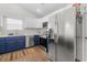 Kitchen with stainless steel appliances, white cabinets, and blue lower cabinets at 445 Saint Charles Circle, Myrtle Beach, SC 29588