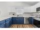 Kitchen featuring blue lower cabinets and white upper cabinets at 445 Saint Charles Circle, Myrtle Beach, SC 29588