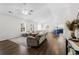 Open-concept living room with hardwood floors and adjacent kitchen and dining area at 445 Saint Charles Circle, Myrtle Beach, SC 29588