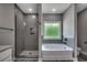 Bright bathroom featuring a soaking tub, a large shower with a glass door, and neutral color scheme at 646 Sunny Pond Ln., Aynor, SC 29511
