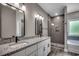 Modern bathroom with double vanity, granite countertop, stylish mirrors, and a separate shower at 646 Sunny Pond Ln., Aynor, SC 29511
