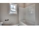 Bright bathroom featuring a white shower-tub combination and a window for natural light at 646 Sunny Pond Ln., Aynor, SC 29511