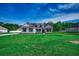 Expansive front lawn leading up to a charming home, set against a clear blue sky at 646 Sunny Pond Ln., Aynor, SC 29511