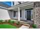 Charming home exterior with a black front door, gray siding, and fresh landscaping at 646 Sunny Pond Ln., Aynor, SC 29511