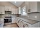 Well-equipped kitchen boasting granite countertops, stainless steel appliances, and ample storage space at 646 Sunny Pond Ln., Aynor, SC 29511