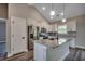 Modern kitchen featuring an island with a sink, granite countertops and stainless steel appliances at 646 Sunny Pond Ln., Aynor, SC 29511