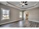 Spacious main bedroom features a ceiling fan, tray ceiling, and two bright windows at 646 Sunny Pond Ln., Aynor, SC 29511