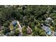 Aerial view of homes nestled within a tree-filled neighborhood near a small lake at 133 Otter Run Rd., Pawleys Island, SC 29585
