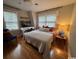 Cozy bedroom with hardwood floors, natural light from two windows, and a decorative accent chair providing a comfortable retreat at 133 Otter Run Rd., Pawleys Island, SC 29585